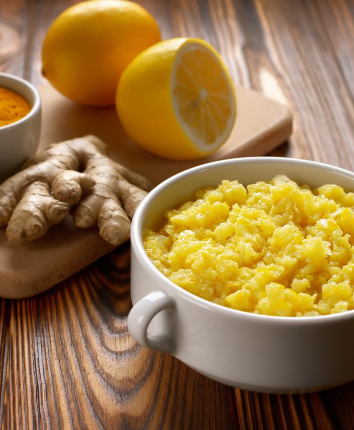 Bowl of natural home made remedy for immune system with lemon and ginger with garlic.
