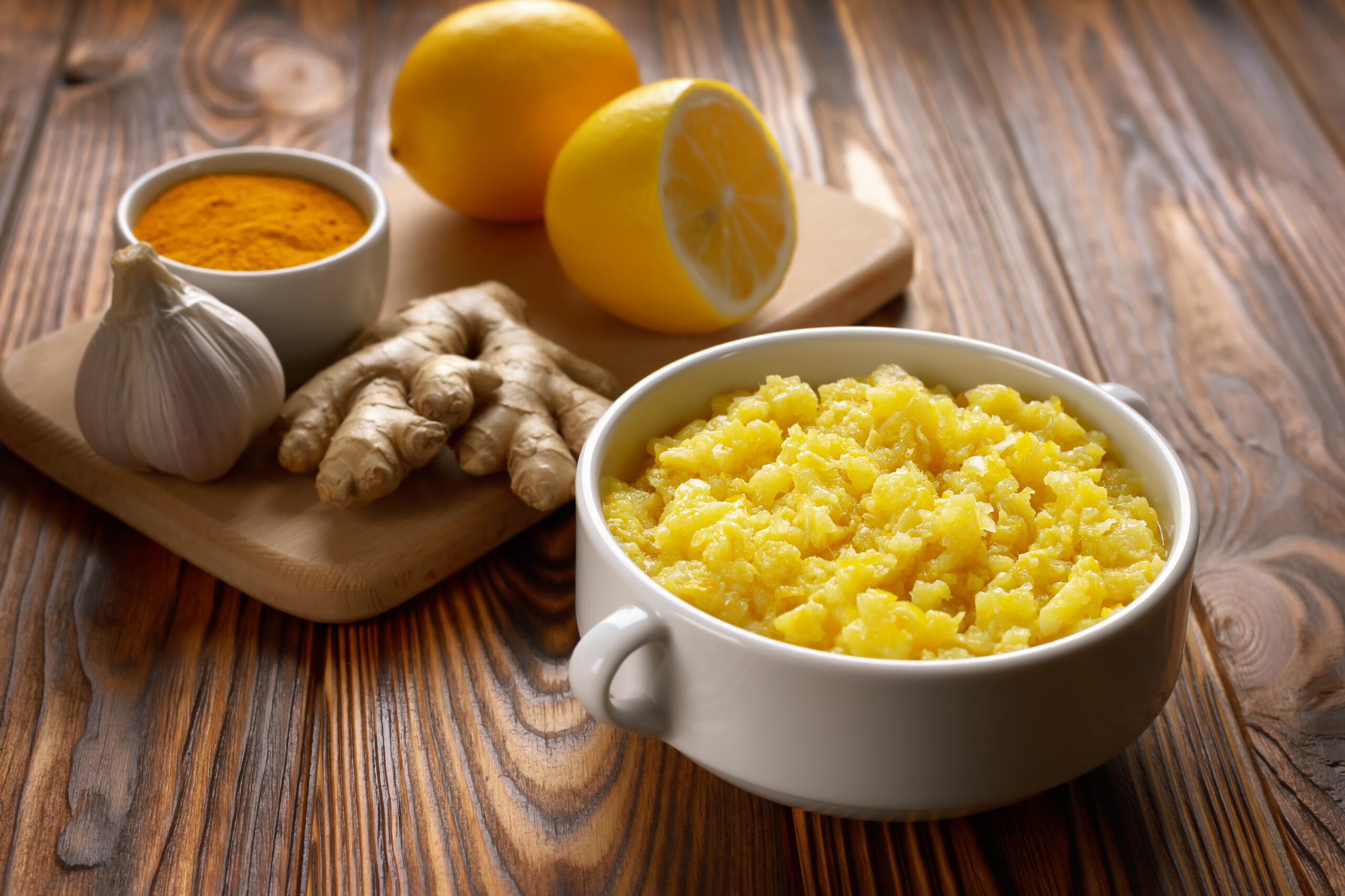 Bowl of natural home made remedy for immune system with lemon and ginger with garlic.